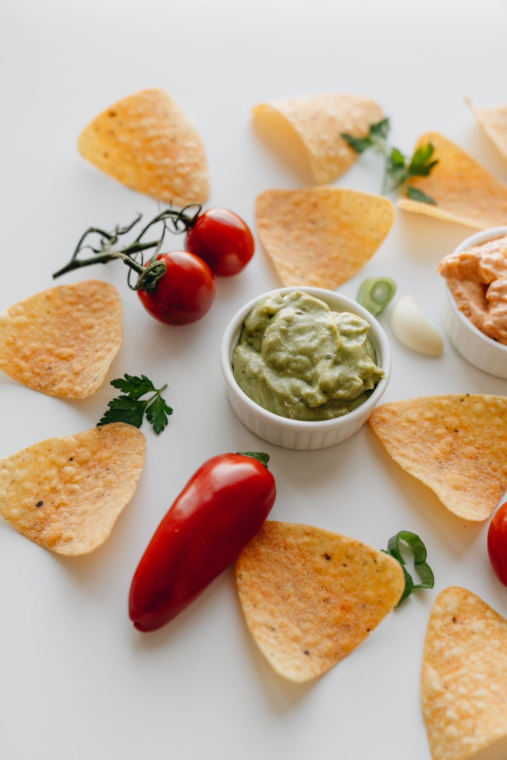 Bowl of guacamole with nacho chips